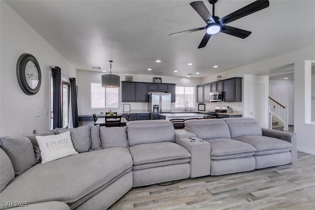 living area featuring a healthy amount of sunlight, recessed lighting, and light wood-style flooring