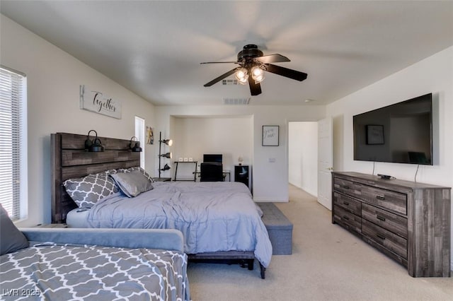 bedroom featuring light colored carpet, a ceiling fan, and visible vents