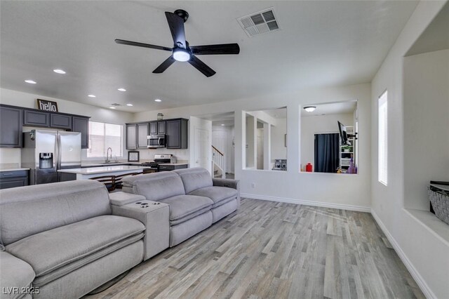 2929 Salado Creek Ave, North Las Vegas, NV 89081 - living room featuring light wood-type flooring, ceiling fan, recessed lighting, baseboards, and stairs