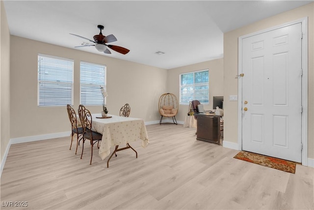 dining room featuring baseboards, light wood-style floors, visible vents, and ceiling fan