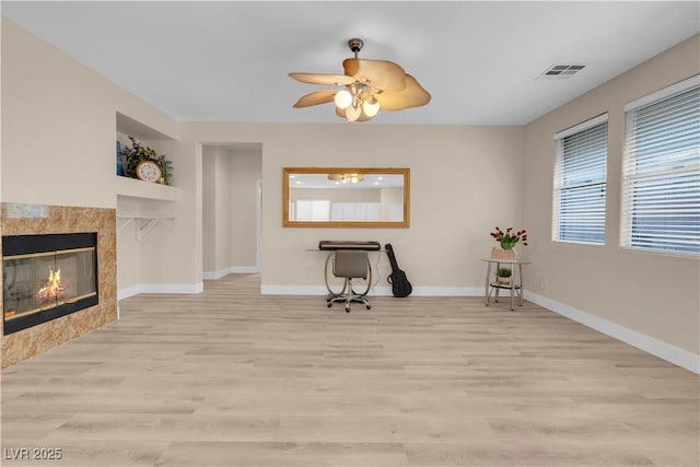unfurnished room featuring baseboards, visible vents, and wood finished floors