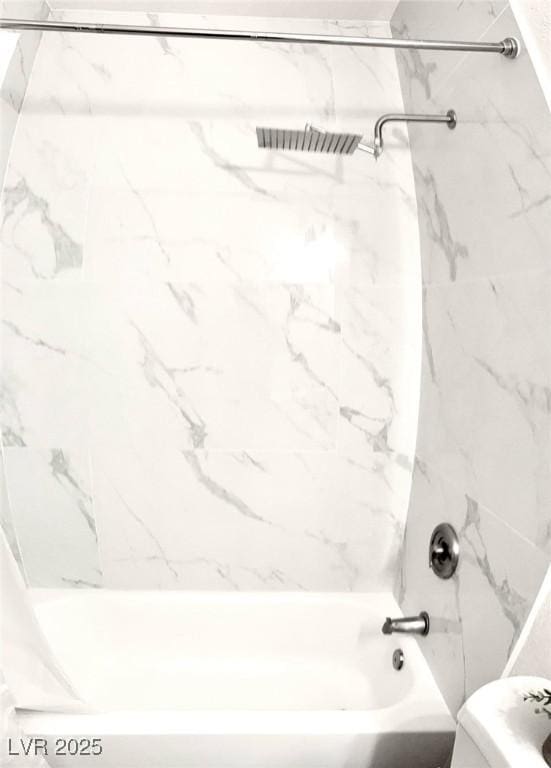 bathroom with toilet and  shower combination