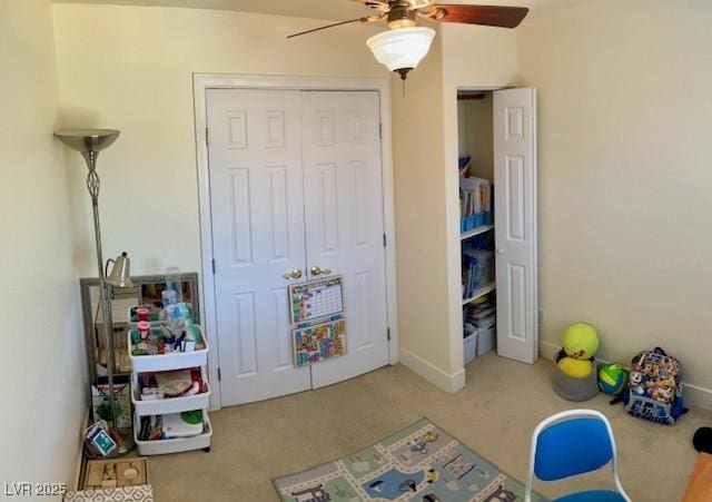 game room with carpet flooring and ceiling fan