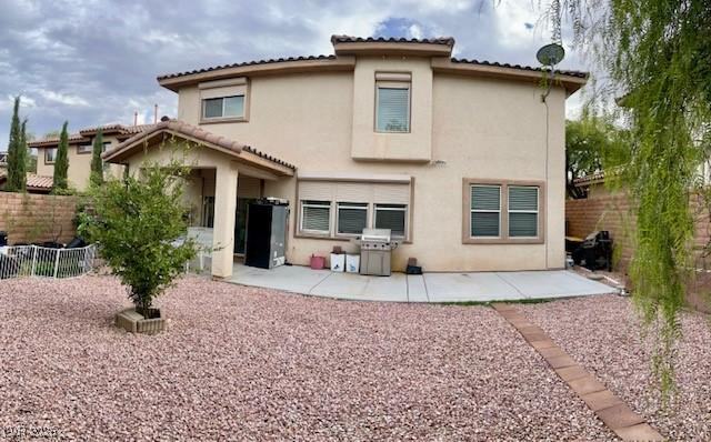 back of property featuring a patio area, stucco siding, and a fenced backyard