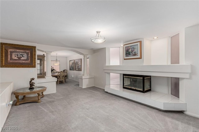1066 Aspen Valley Ave, Las Vegas, NV 89123 - carpeted living area featuring arched walkways, baseboards, and decorative columns