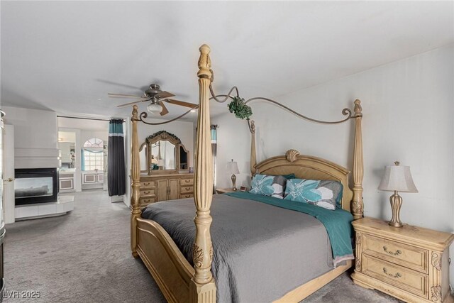 1066 Aspen Valley Ave, Las Vegas, NV 89123 - bedroom featuring a ceiling fan, carpet, and a tile fireplace