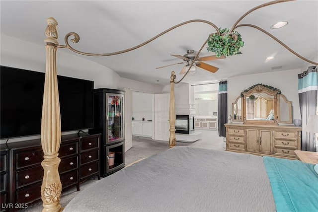 1066 Aspen Valley Ave, Las Vegas, NV 89123 - carpeted bedroom featuring recessed lighting, a ceiling fan, a multi sided fireplace, and ensuite bath