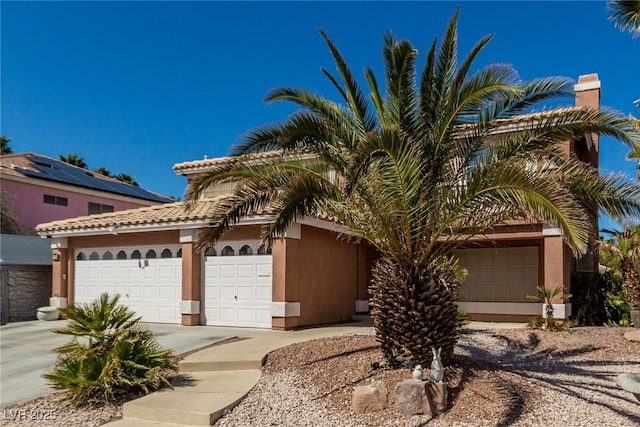 1066 Aspen Valley Ave, Las Vegas, NV 89123 - mediterranean / spanish home with an attached garage, concrete driveway, a tile roof, and stucco siding