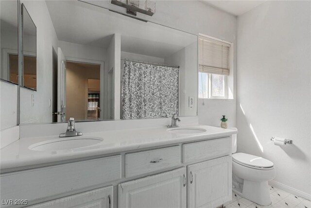 1066 Aspen Valley Ave, Las Vegas, NV 89123 - bathroom featuring a sink, baseboards, toilet, and double vanity