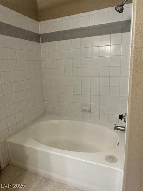 full bath with tile patterned floors, shower / bathing tub combination, and a textured wall