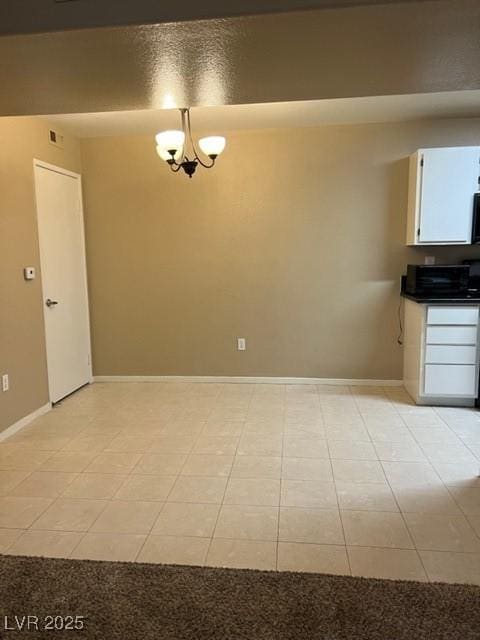 unfurnished dining area featuring baseboards, a chandelier, light tile patterned flooring, and visible vents