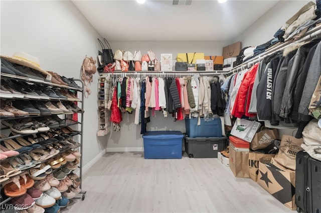 spacious closet featuring visible vents and wood finished floors