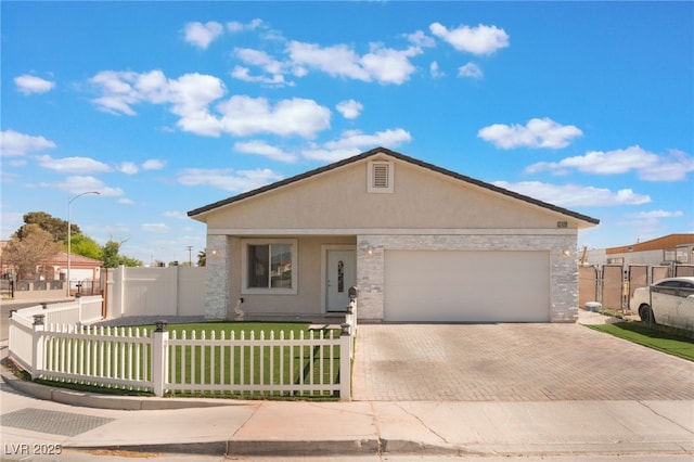 ranch-style home featuring a fenced front yard, a garage, decorative driveway, a front lawn, and stucco siding