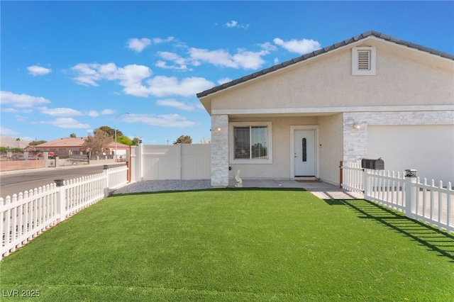 rear view of property with a fenced backyard, stucco siding, a lawn, and a garage