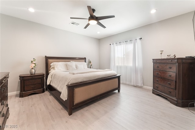 bedroom featuring visible vents, light wood-style flooring, ceiling fan, and baseboards