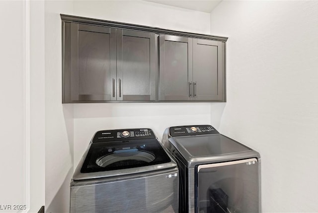 clothes washing area featuring cabinet space and independent washer and dryer