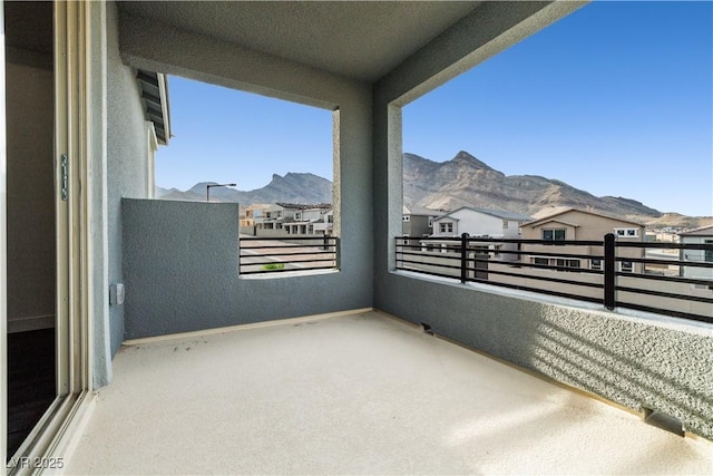 balcony featuring a residential view and a mountain view