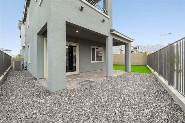 back of property featuring a patio, a fenced backyard, and stucco siding