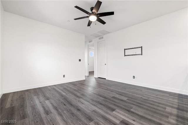 empty room with dark wood-style flooring, ceiling fan, visible vents, and baseboards
