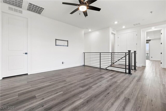 unfurnished room with visible vents, recessed lighting, ceiling fan, and wood finished floors