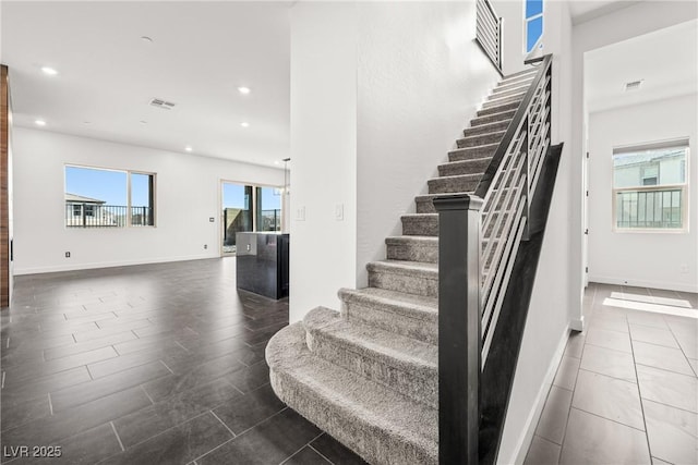 stairway with recessed lighting, baseboards, and visible vents