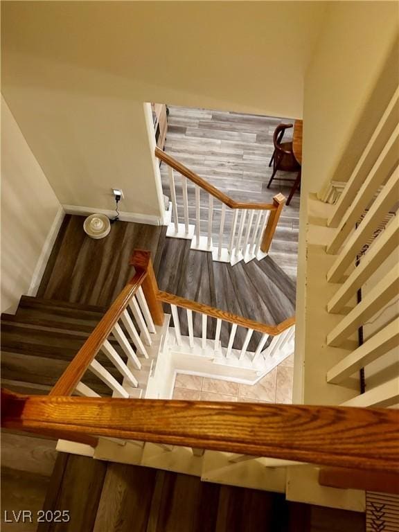 stairs featuring wood finished floors