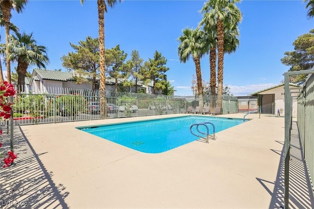 pool featuring fence and a patio