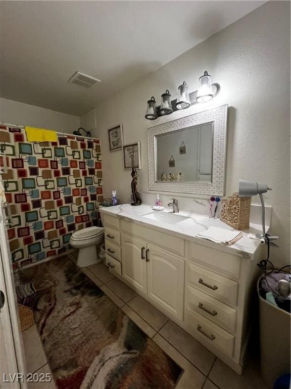 1440 Vegas Valley Dr Unit 2, Las Vegas, NV 89169 - bathroom with vanity, tile patterned floors, visible vents, and toilet