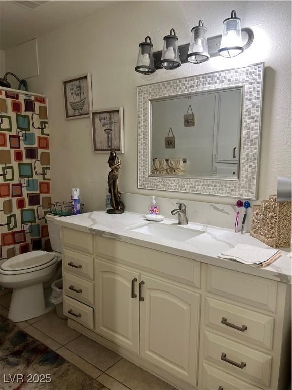 1440 Vegas Valley Dr Unit 2, Las Vegas, NV 89169 - bathroom with vanity, a shower with shower curtain, tile patterned floors, and toilet