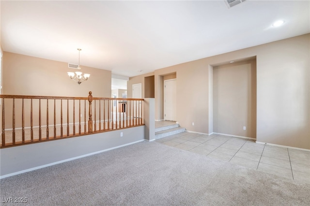 spare room featuring visible vents, baseboards, light colored carpet, a chandelier, and light tile patterned floors