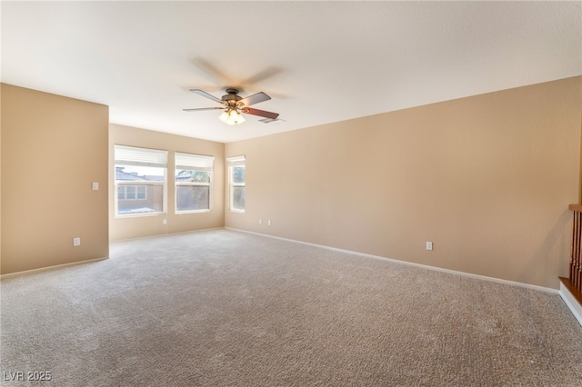 spare room with baseboards, ceiling fan, carpet flooring, and visible vents