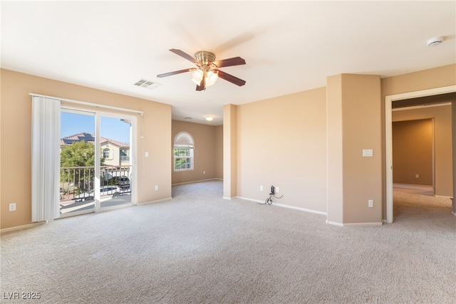 empty room featuring baseboards, a ceiling fan, carpet flooring, and visible vents