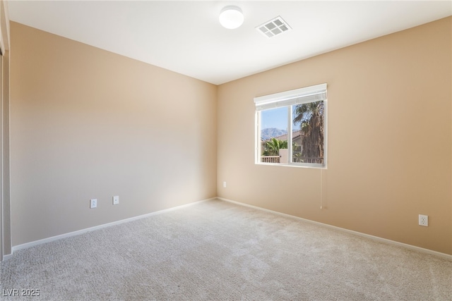 unfurnished room featuring carpet floors, baseboards, and visible vents