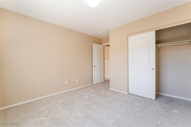 unfurnished bedroom with baseboards, carpet, and a closet