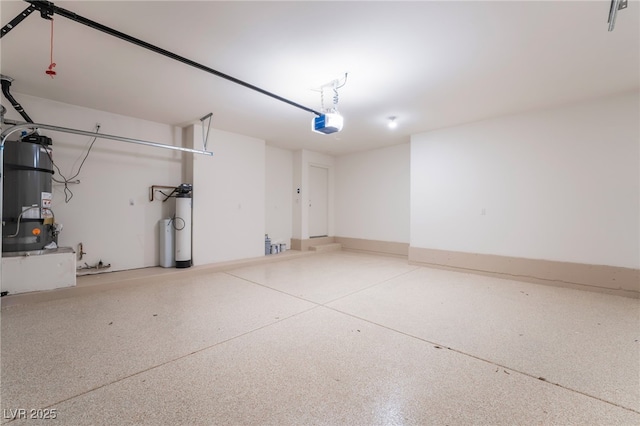 garage with a garage door opener, water heater, and gas water heater