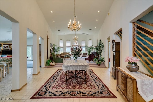 interior space with an inviting chandelier, high vaulted ceiling, and recessed lighting