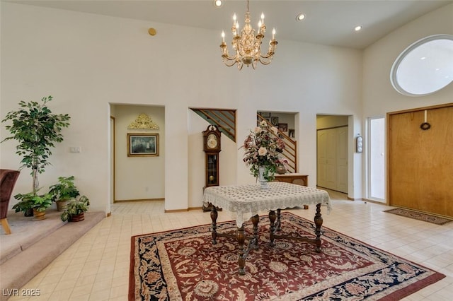 entrance foyer with light tile patterned floors, baseboards, a chandelier, a high ceiling, and recessed lighting