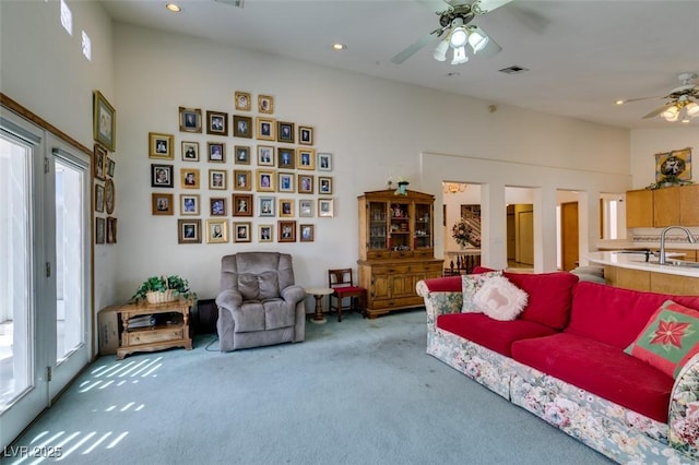 carpeted living room featuring a sink, a ceiling fan, recessed lighting, and visible vents