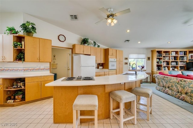 kitchen featuring visible vents, open shelves, a sink, light countertops, and white appliances