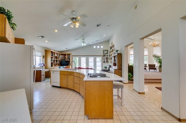 kitchen featuring a sink, a wealth of natural light, white appliances, and open floor plan