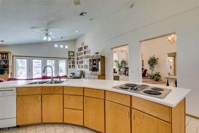 kitchen with open floor plan, stainless steel electric cooktop, a sink, ceiling fan with notable chandelier, and dishwasher