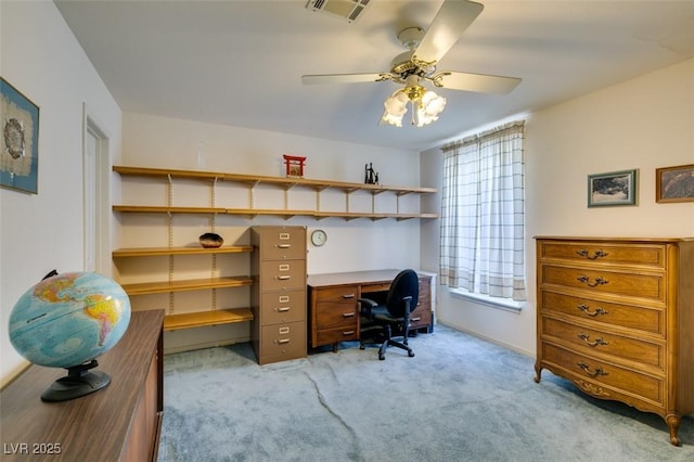 office space with visible vents, a ceiling fan, baseboards, and light colored carpet