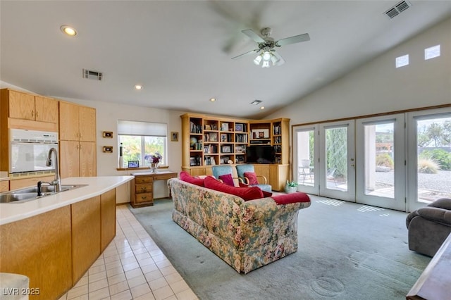 living area featuring recessed lighting, visible vents, light carpet, and light tile patterned floors
