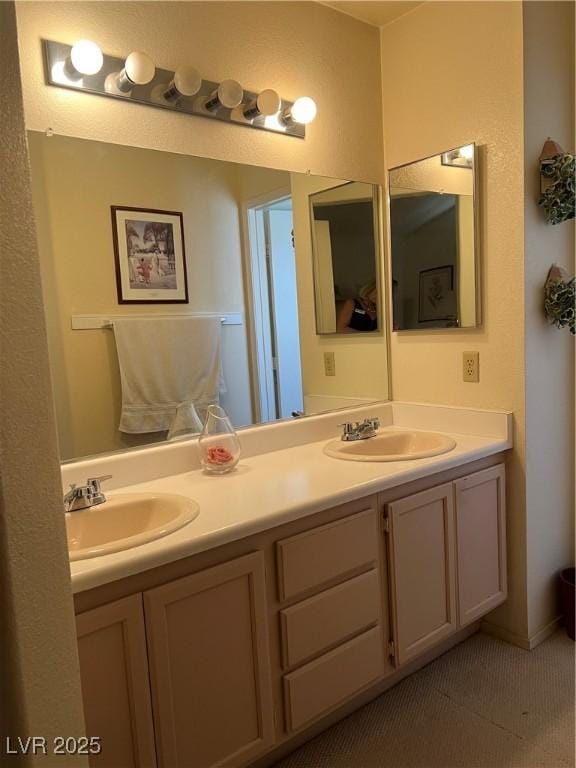 bathroom featuring a sink and double vanity