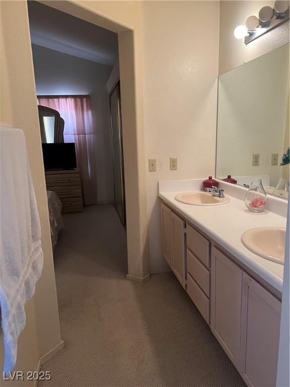 full bathroom featuring a sink and double vanity