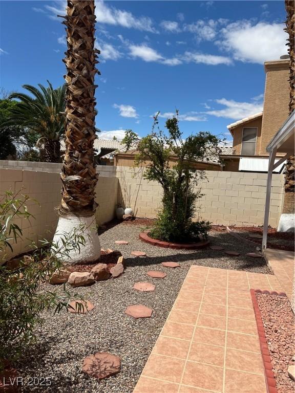 view of yard featuring fence and a patio
