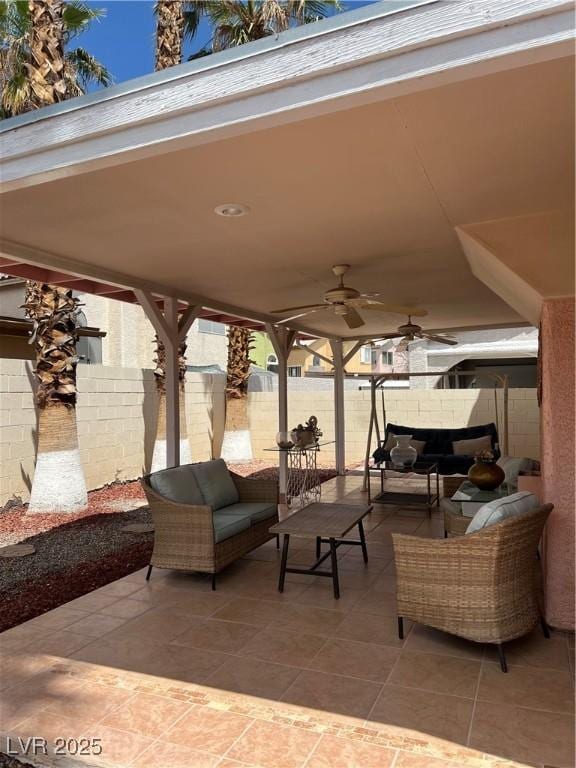 view of patio / terrace featuring fence, outdoor lounge area, and a ceiling fan