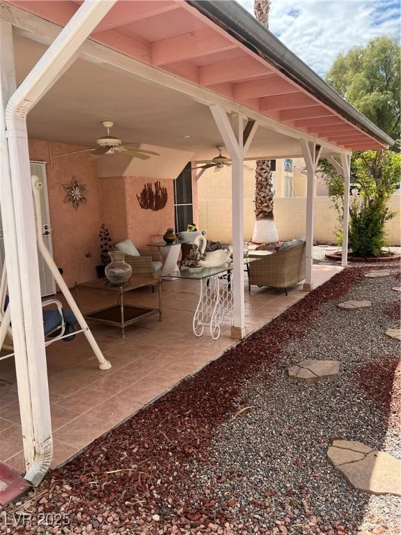 view of patio / terrace with fence, ceiling fan, and outdoor lounge area