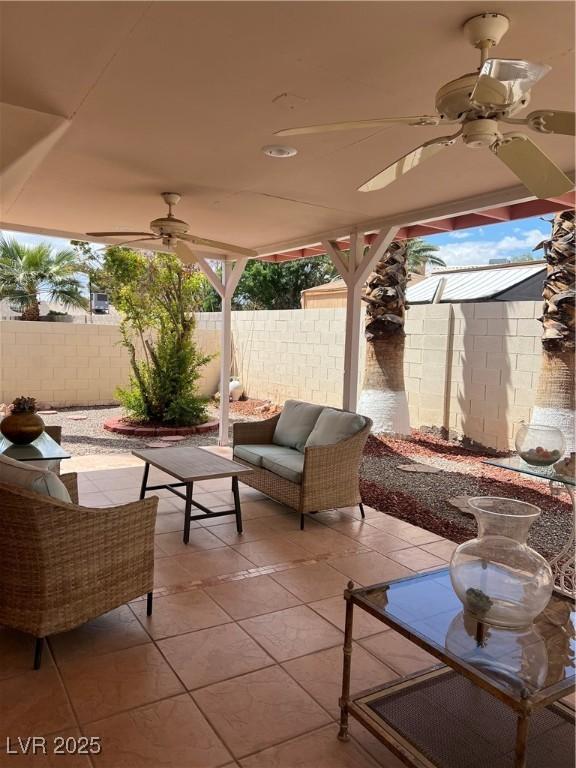 view of patio featuring fence and a ceiling fan