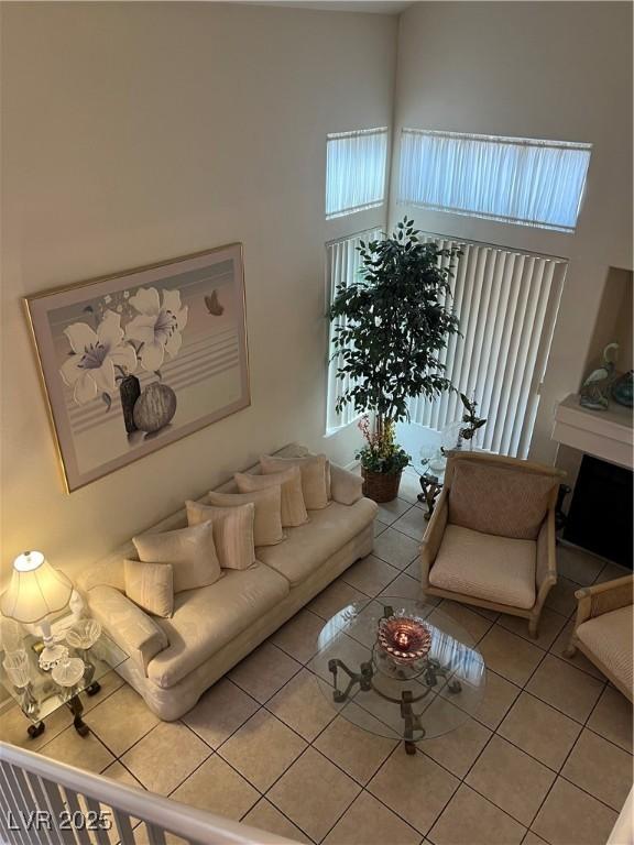 living area featuring light tile patterned floors and a high ceiling